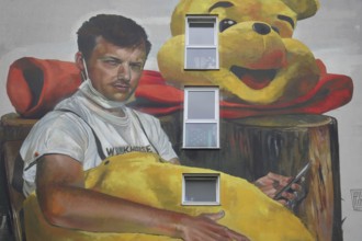 Mural Waldsterben by CASE MaClaim 2024, man with yellow plush toy, bear figure, street art,