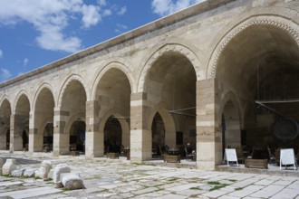 Arcades with ancient stone vaults, with ruins in the foreground of a historic building, courtyard,