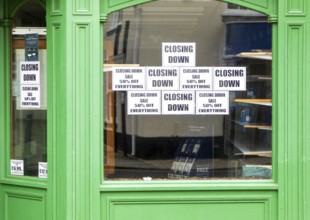 Shop window signs with empty shelves closing down sale, Beccles, Suffolk, England, UK