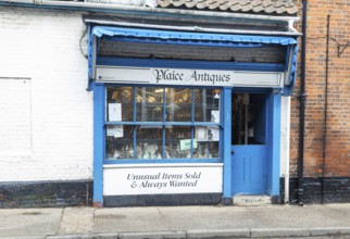 Shop window shopfront of small specialist antique shop, Plaice Antiques, Beccles, Suffolk, England,