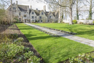 Flower beds lawn and garden path, historic manor house building, Avebury Manor, Wiltshire, England,