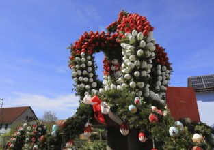 Detail of an Easter fountain in Franconian colors red and white, Franconian Switzerland, in