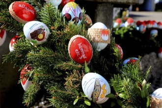 Detail of an Easter fountain in Franconian colors red and white, eggs with inscriptions on