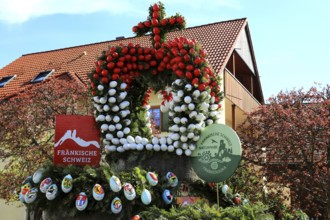 Detail of an Easter fountain in Franconian colors red and white, Franconian Switzerland, in