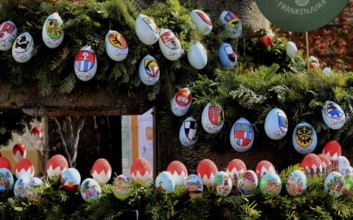 Detail of an Easter fountain in Franconian colors red and white, eggs with coats of arms of the