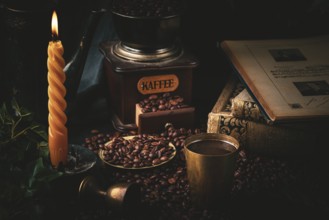 Still life with coffee mug, burning candle, coffee grinder and old books