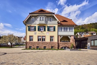 Town hall, commercial building, façade with windows, shutters and façade painting, hipped roof,