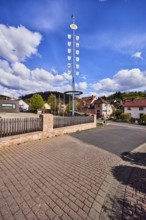 Maypole, sandstone wall, wooden fence, roads, general buildings, residential buildings, hills,