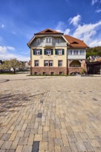 Town hall, commercial building, façade with windows, shutters and façade painting, hipped roof,