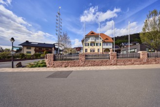 Town hall, maypole, flagpoles, lantern, sandstone wall, wooden fence, street, general development,