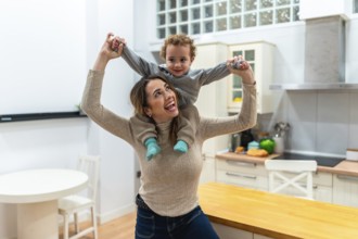 Mother enjoying playtime with her son on a piggyback ride at home, sharing laughter and bonding