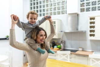 Mother feeling joy and bonding with her playful son during a piggyback ride at home, highlighting