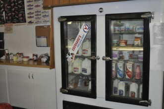 An ancient cooling rack with various drinks and food in a small shop, Mitchell, Oregon, USA