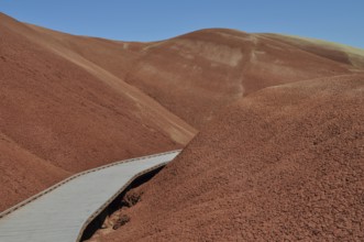 Wooden trail through red, hilly landscape, John Day Fossil Beds National Monument, Painted Hills