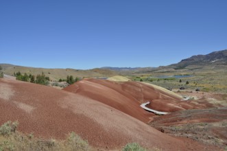 A landscape of colorful hills under a clear blue sky, John Day Fossil Beds National Monument,