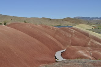Winding wooden trail through red mounds, John Day Fossil Beds National Monument, Painted Hills