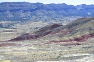 Wide landscape with colorful hills and red stripes in the foreground, John Day Fossil Beds National