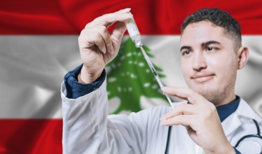 Doctor holding syringe on Lebanon flag background. Medical professional holding syringe with