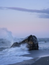 Okarito Beach, rocks, ocean, sandy beach. In the evening. long exposure. Westland Tai Poutini