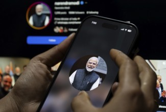 In this photo illustration, a close view of a smartphone displaying the profile picture of Indian