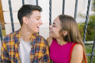 A happy lesbian couple shares a joyful moment in an urban setting, highlighting love and connection