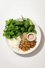 Top view of a plate with fresh ingredients for making Italian pesto gnocchi, featuring potatoes,