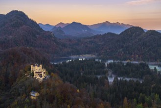 Scenic view of Hohenschwangau Castle amidst the vibrant autumn foliage of the Bavarian Alps The