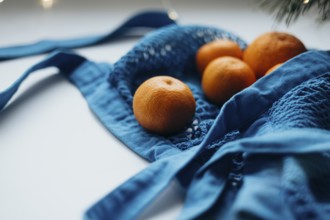Close-up view of ripe tangerines neatly tucked inside a vibrant blue string bag, set against a
