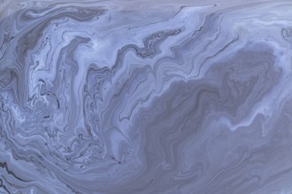 A detailed close up of abstract acrylic paint gray marble with swirling patterns. This intricate