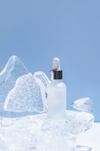 A serene image showcasing a clear serum bottle placed on an icy sculpture, illuminated with a soft