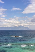 Captivating view of the Aegean Sea with vibrant blue and turquoise waters in Greece. Mount Athos