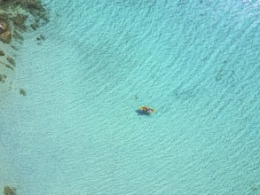 A stunning aerial view of Diaporos Island in Greece, showcasing crystal-clear turquoise waters with