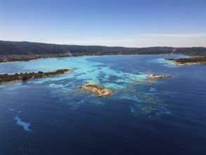 Drone view of Diaporos Island and Karydi Beach in Greece, showcasing crystal-clear turquoise