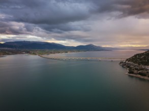 A stunning aerial view of Lake Polyfyto with the Servia Neraida high bridge spanning the water.