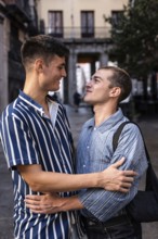 Gay couple embraces on the charming streets of Madrid, sharing a moment of affection. Capturing the