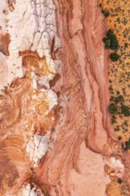 Stunning top-down view of intricate red and white rock patterns in a desert landscape, showcasing