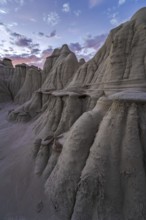 Striking geological formations at twilight in Bisti/De-Na-Zin Wilderness, New Mexico, USA,