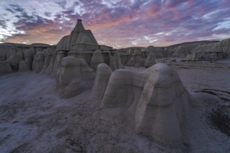 Dramatic sunset illuminating the unique rock formations of Bisti/De-Na-Zin Wilderness in New