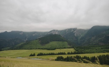 Scenic view of the verdant meadows and foggy peaks in Bachledka Ski Sun region, overlooking the