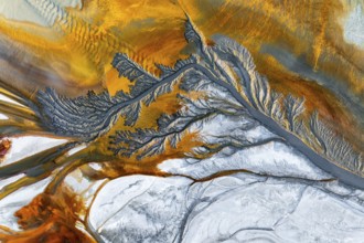 Explore intricate fractal mud textures with vivid earthy tones. This aerial view showcases stunning