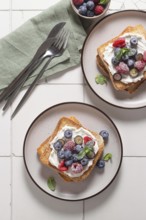 Top view of delicious breakfast setup featuring toast slathered with cream cheese and topped with