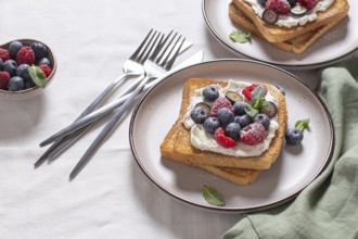 Delicious serving of toast laden with cream cheese and topped with fresh raspberries and