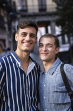 A joyful gay couple enjoying a sunny day on the bustling streets of Madrid, showcasing pride and