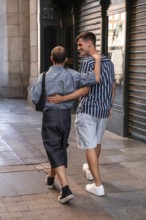 A joyful gay couple strolls arm in arm on a lively street in Madrid. Their relaxed, happy demeanor