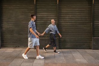 A gay couple enjoying a leisurely walk hand in hand along the charming streets of Madrid, exuding