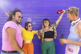 Vibrant group of LGBTQIA+ friends enjoying a sunny day together. They share laughter, drinks, and