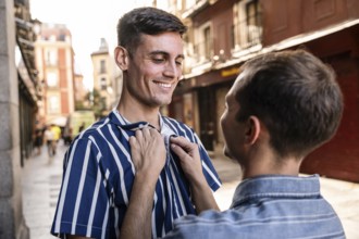 A gay couple shares a tender moment on the streets of Madrid. Capturing love and connection in a