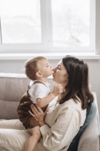 A heartwarming scene of a son kissing their mother on the nose, capturing love and affection in a