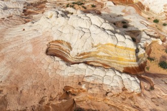 Aerial view of sandstone formations showcasing layered textures and vibrant colors in White Pocket.