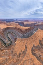 Aerial view of San Juan canyon with a winding river cutting through the arid desert landscape. The